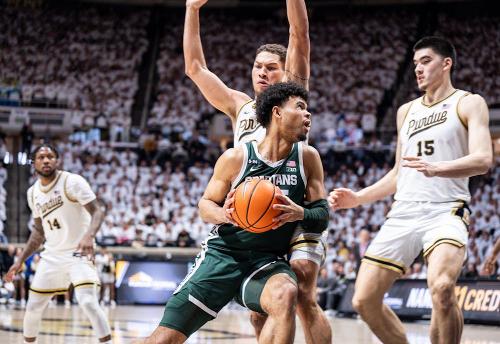 <p>Senior forward Malik Hall (25) gets past his opponents to try and shoot the ball during a game against Purdue at Mackey Arena on Jan. 29, 2023. The Spartans lost to the Boilermakers 77-61.</p>