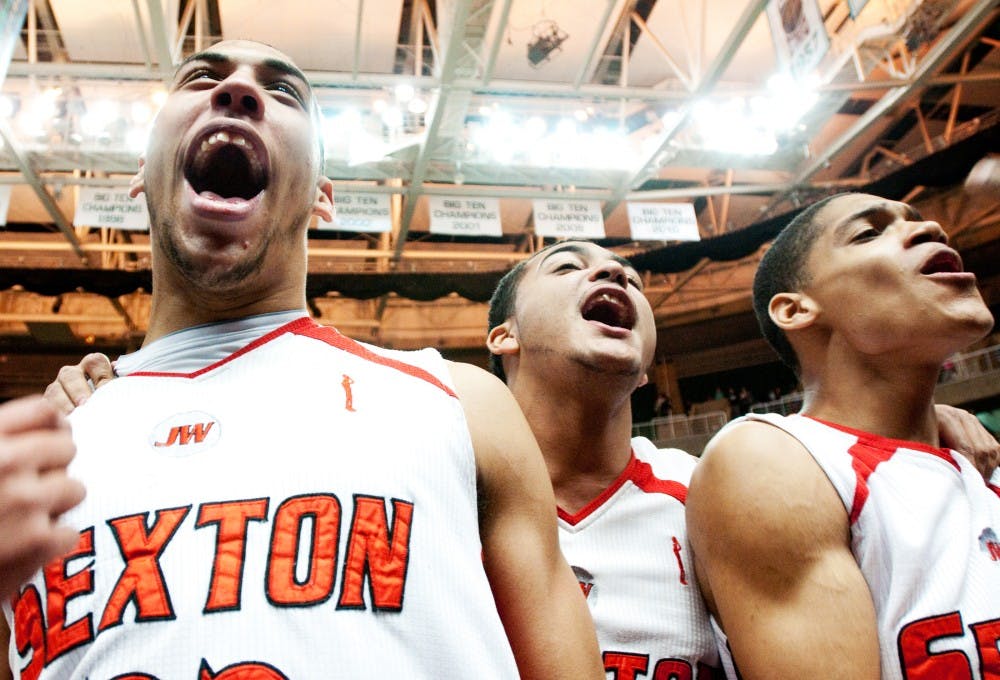 MSU recruit Denzel Valentine of Lansing Sexton, left, celebrates with his teammates after winning the MHSAA Class B Final game against Muskegon Heights on Saturday afternoon at Breslin Center. Josh Radtke/The State News