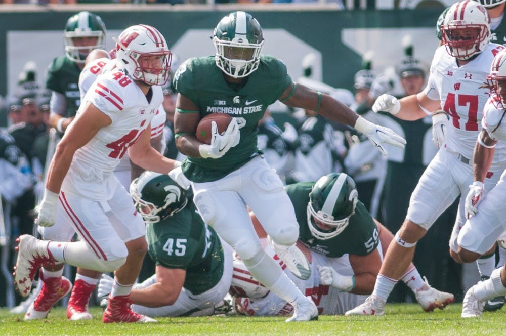 Sophomore running back LJ Scott (3) runs the ball during the game against Wisconsin on Sept. 24, 2016 at Spartan Stadium. The Spartans were defeated by the Badgers, 30-6.