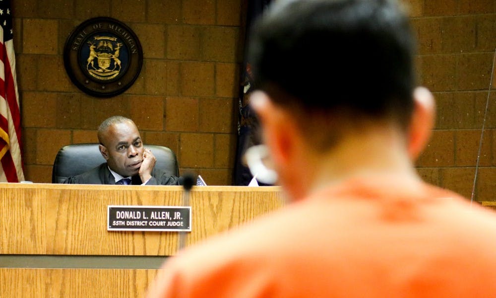 <p>Judge Donald Allen Jr looks at Larry Nassar during the final day of the preliminary examination hearing in the 55th District Court on June 23.</p>