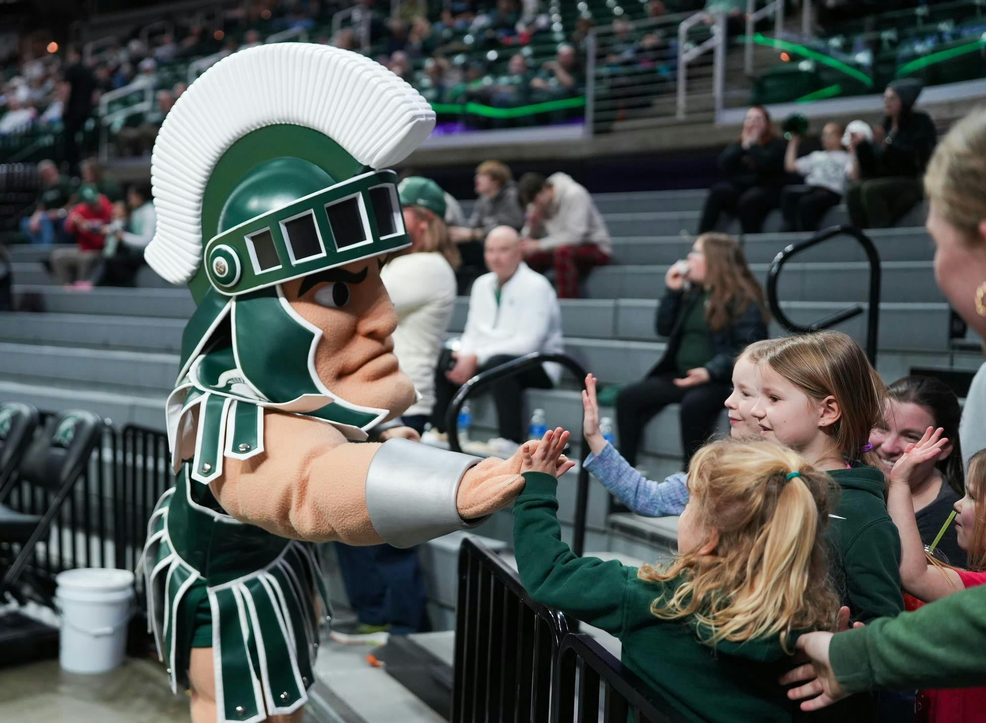Sparty greets fans at the Michigan State vs Wisconsin womens basketball game on Feb. 12, 2025. Sparty is always in attendance at campus events, and is there to support the students. 
