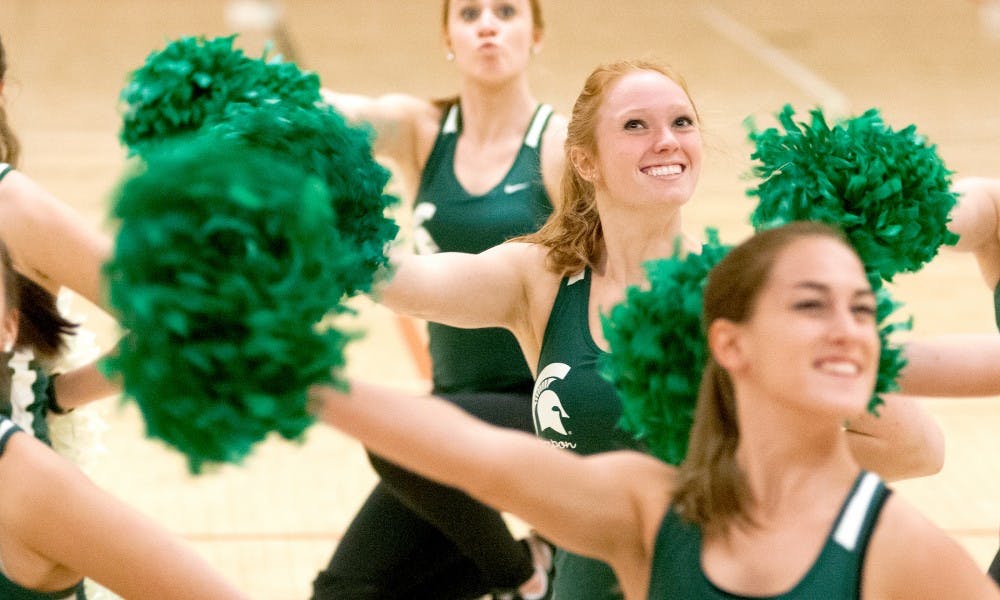 <p>Physiology junior Renee Weil, center, dances at a MSU Pompon practice on Oct. 22, 2015, at IM Sports-Circle. The team was established in 2005 and is recognized by the MSU Recreation Sports Department as a competitive student organization club sport. </p>