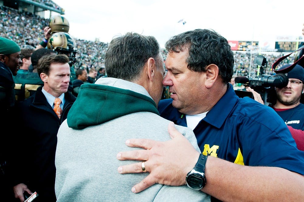 	<p>Head coach Mark Dantonio, left, meet Michigan head coach Brady Hoke at midfield after the Spartans defeated U-M on Oct. 15, 2011 at Spartan Stadium.</p>