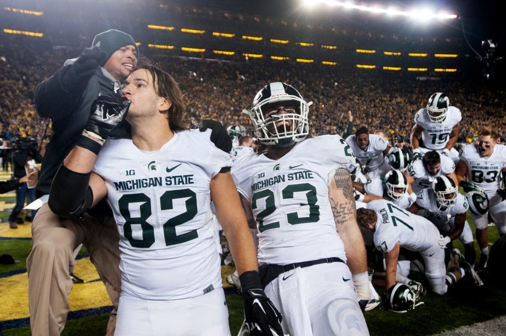 <p>Junior tight end Josiah Price, 82, and sophomore linebacker Chris Frey celebrate after the game against Michigan, on Oct. 17, 2015 at Michigan Stadium. The Spartans defeated the Wolverines 27-23.</p>