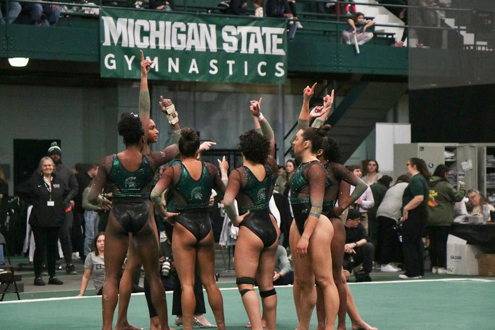 <p>MSU gymnasts come together for a team cheer before beginning the floor event against University of Iowa at Jenison Field House on Jan. 28, 2024.</p>