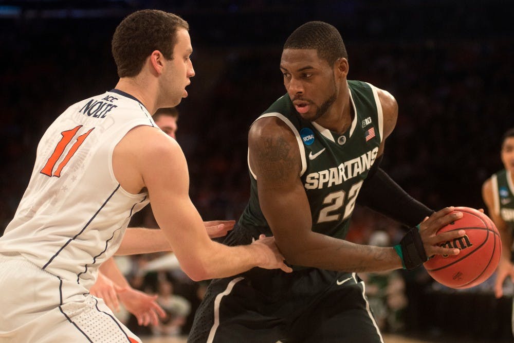 <p>Junior guard/forward Branden Dawson looks to pass around Virginia forward Evan Nolte on March 28, 2014, at Madison Square Garden in New York City during the NCAA tournament. The Spartans won, 61-59. Julia Nagy/The State News</p>