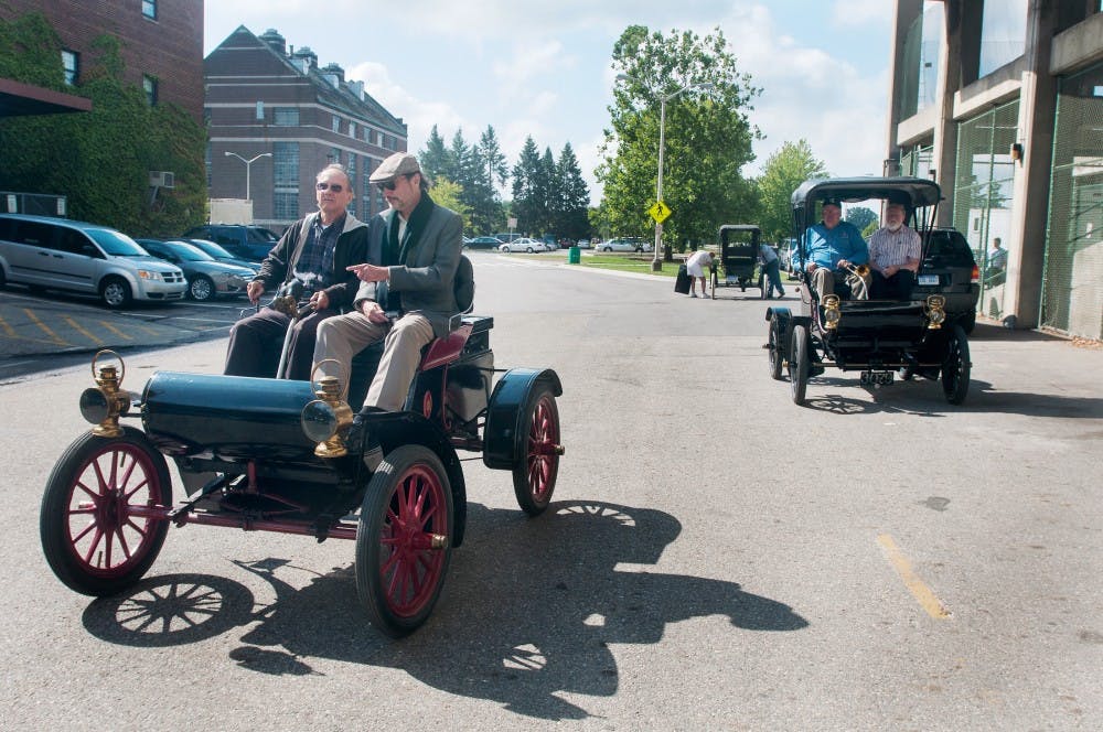 People driving Oldsmobiles prepare to caravan to the R.E. Olds Transportation Museum in Lansing on Tuesday, Aug. 14, 2012, from Spartan Stadium. Samantha Radecki/The State News