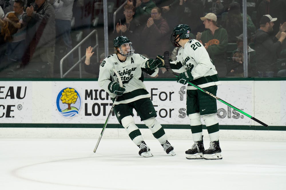 <p>Michigan State forwards No. 28 Karsen Dowart and No. 20 Daniel Russell celebrate a goal at Munn Ice Arena in East Lansing, Michigan on Jan. 26, 2024. Michigan State secured a huge win to take a commanding lead of first in the Big Ten.</p>