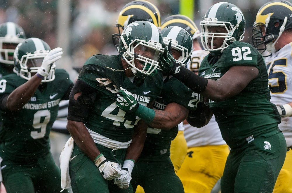 <p>Sophomore linebacker Ed Davis gets pumped up after making a play during the game against Michigan on Nov. 2, 2013, at Spartan Stadium. The Spartans defeated the Wolverines, 29-6. Khoa Nguyen/The State News</p>
