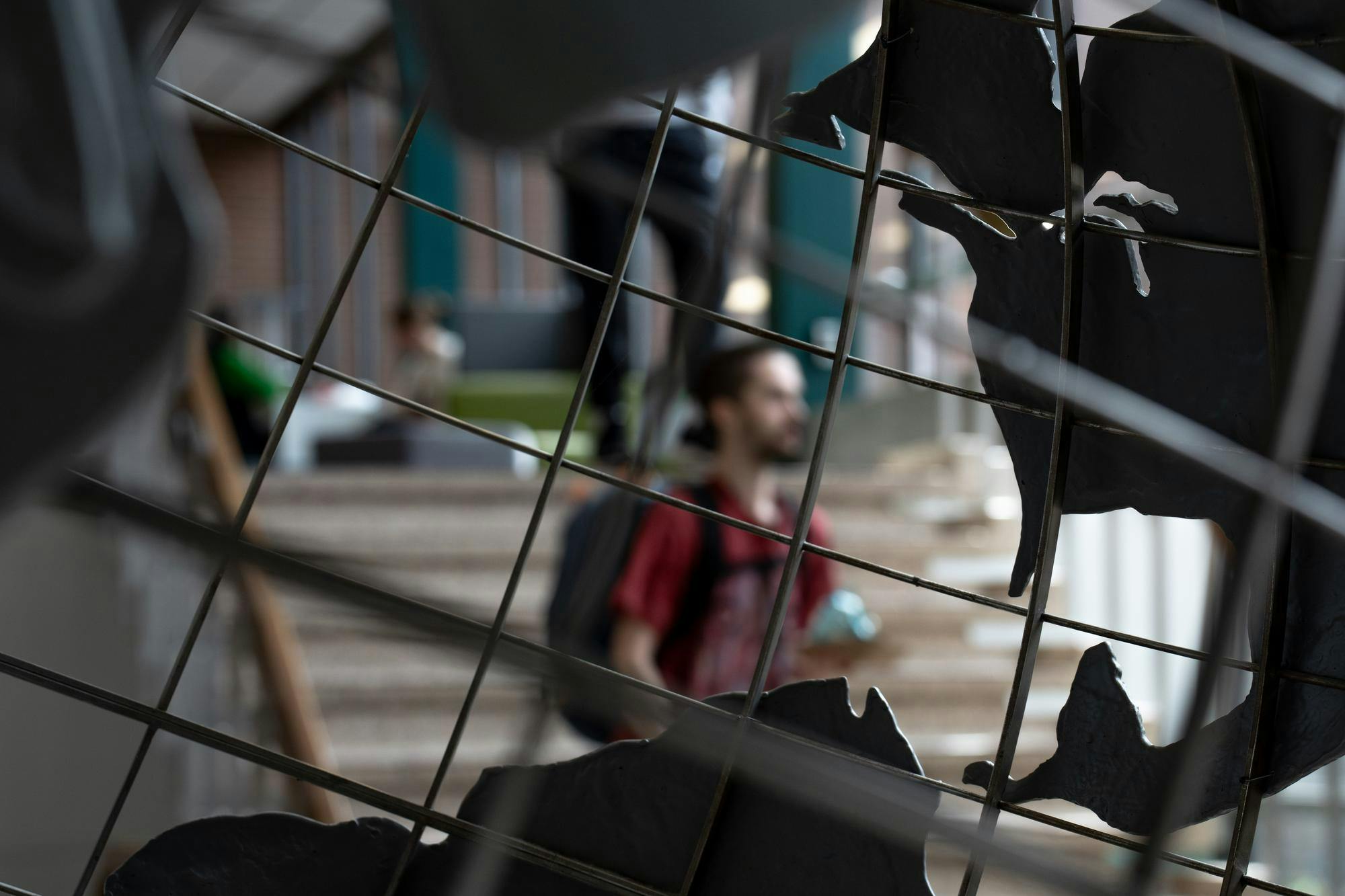 A student walks past the sculpture of the globe in the International Center on April 17, 2025.