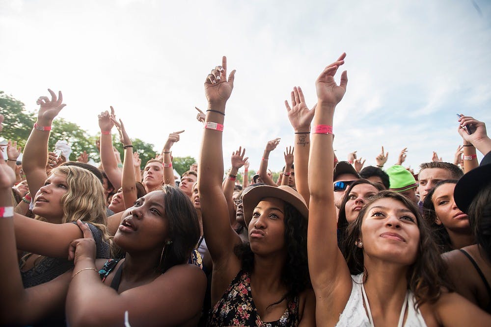 <p>Fans cheer as Juicy J enters Auto Value Main Stage on July 11, 2014, at Adado Riverfront Park in downtown Lansing. Common Ground Music Festival is in its 15th year of performances. Corey Damocles/The State News </p>
