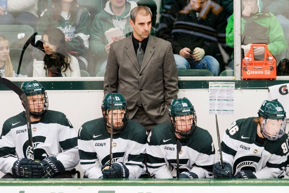 Head coach Tom Anastos and his fellow players look onto the ice when MSU was trailing NMU by one point. The Michigan State Spartans defeated the Northern Michigan Wildcats, 2-1, Saturday night at Munn Ice Arena. Justin Wan/The State News