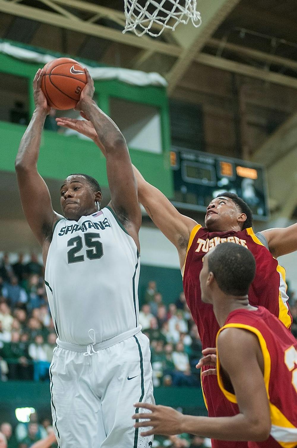 	<p>Senior center Derrick Nix goes up to get a defensive rebound in the second half of the game. The Spartans defeated the Golden Tigers, 92-56, Saturday, Dec. 15, 2012, at Jenison Field House. Justin Wan/The State News</p>