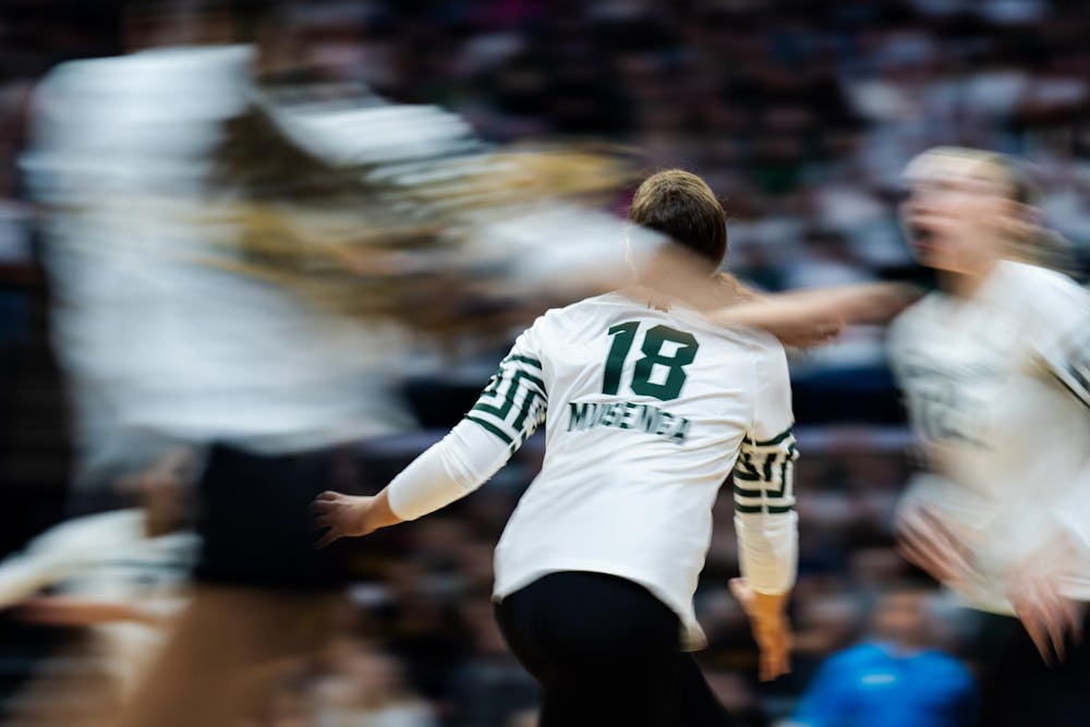 Michigan State senior setter Rachel Muisenga (18) tracks the ball during the game against the University of Michigan at the Breslin Center on Nov. 15, 2024.