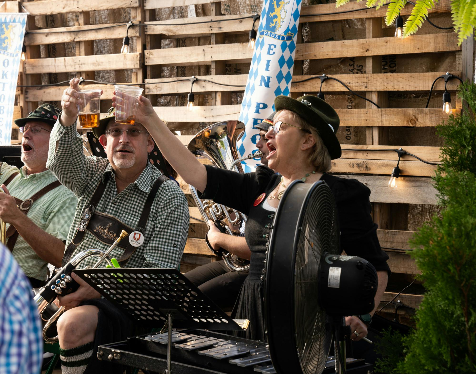 Members of the Katzenjammer German Band cheers during a song at the Horrocks Oktoberfest in Lansing on Oct. 1, 2022. 