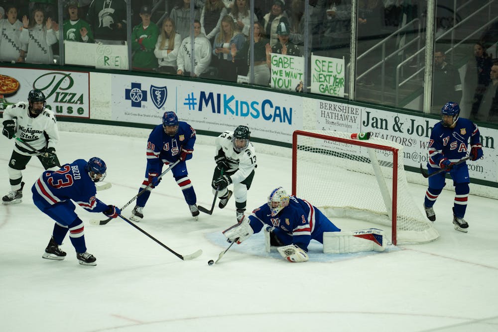 <p>Freshman left wing Tiernan Shoudy (13) attempts to score at Munn Ice Arena on Oct. 1, 2022. The Spartans lost to the USNTDP 4-3.</p>