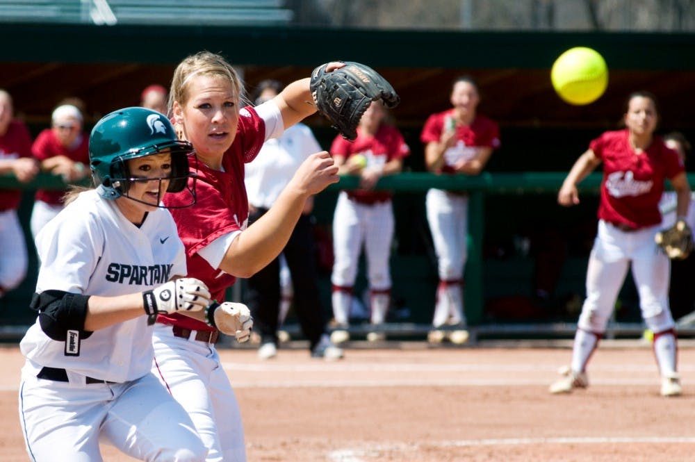 	<p>Sophomore outfielder Kylene Hopkins runs past Indiana pitcher Sara Olson as she attempts to make a catch Saturday afternoon at Secchia Stadium. The Spartans lost Saturday&#8217;s game to Indiana, 7-2.</p>