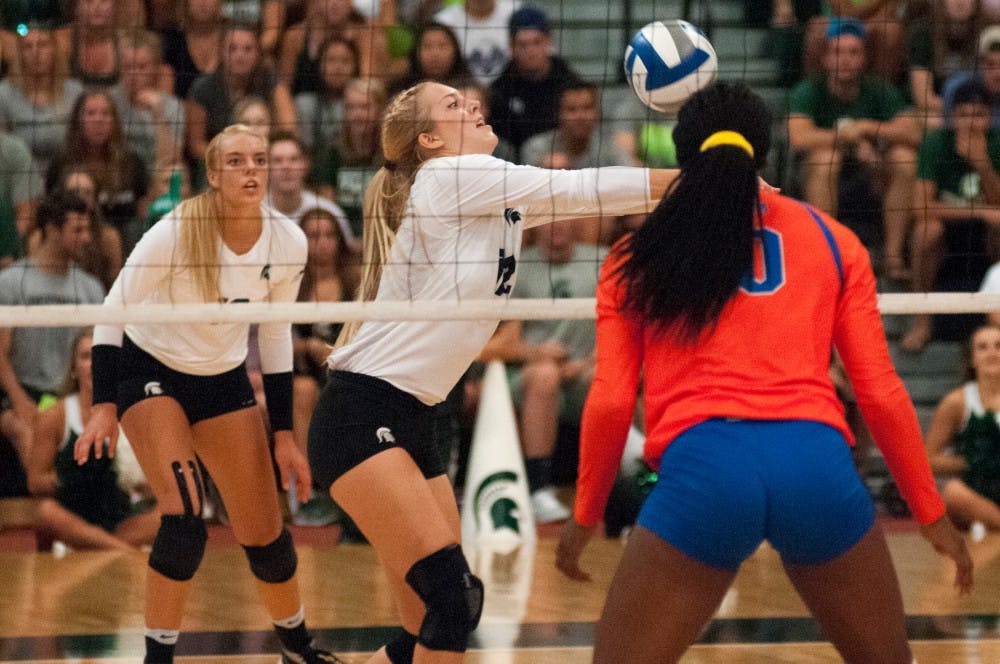 Junior setter Rachel Minarick (12) bumps the volleyball during the volleyball game against the University of Florida on Sept. 4, 2016 at Jenison Field House. The Spartans were defeated by the Gators, 3-0.