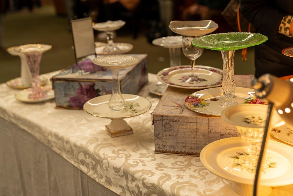 Tea cake plates and glass stands sit on display at a vendor table during Michigan State’s annual winter arts and craft show at the Union on campus in East Lansing, Mich., on Saturday, Dec. 6, 2025.