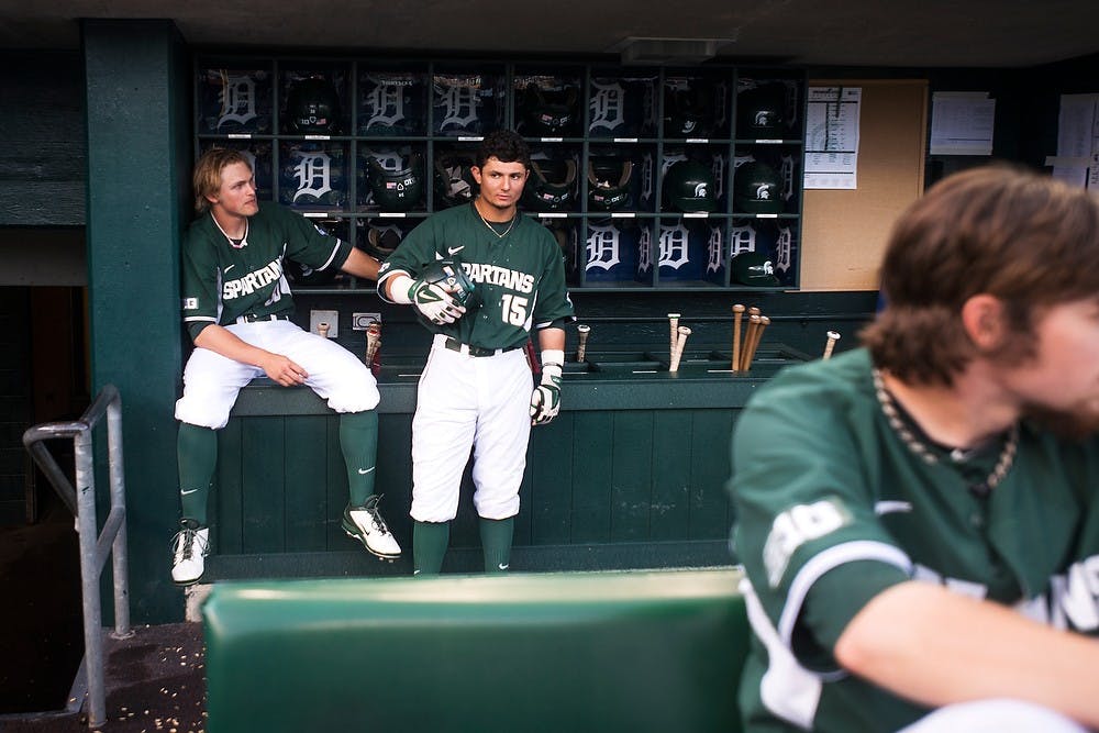 <p>Sophomore left fielder Cam Gibson and Junior center fielder Anthony Cheky, 15, wait in the dugout during a rain delay before the game against Central Michigan on May 13, 2014, at Comerica Park in Detroit. The Chippewas defeated the Spartans, 7-4. Danyelle Morrow/The State News</p>