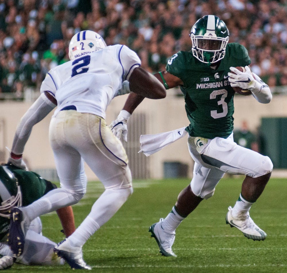 Sophomore running back LJ Scott (3) runs past Furman senior safety Trey Robinson (2) during the home football game against Furman on Sept. 2, 2016 at Spartan Stadium. LJ Scott rushed for a total of 108 yards and scored one touchdown. 