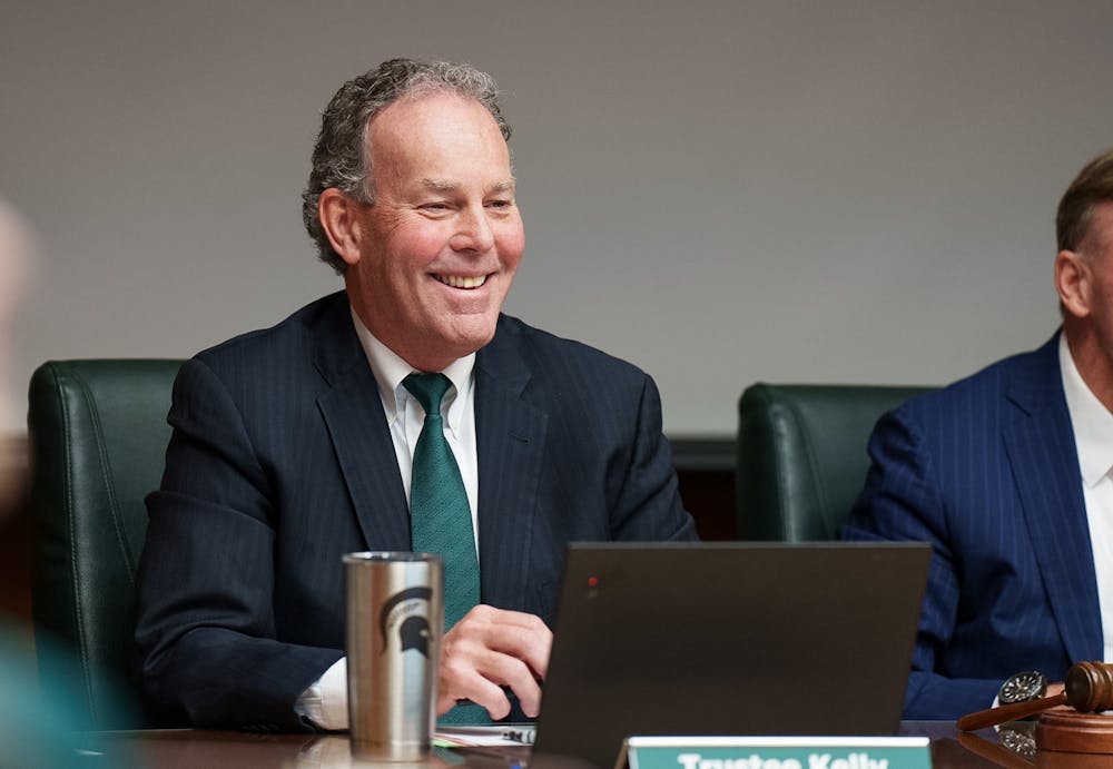 Michigan State Trustee Kelly appears to smile as the trustees and senior Mariam Sayed talk with Dr. Rema over Zoom. The Michigan State University Board of Trustees met in the Hannah Administration Building, on April 22, 2022.