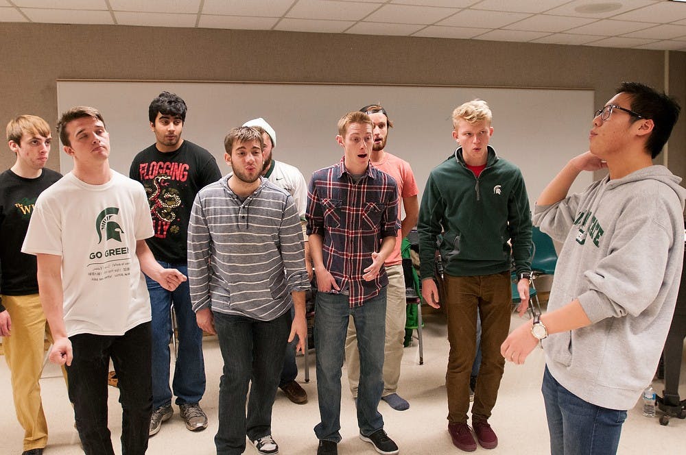 <p>Linguistics senior Andrew Lee leads the Accafellas in a rehearsal Oct, 22, 2014, at the Music building. The Accafellas have competed in the International Championship of Collegiate A Cappella for eight years. Dylan Vowell/The State News</p>