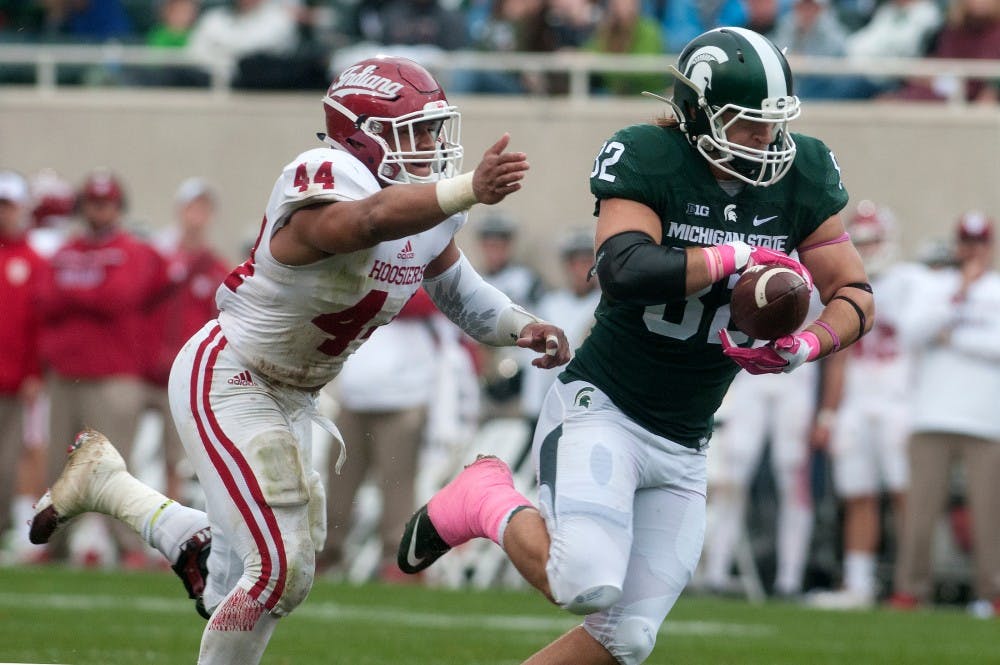 <p>Junior tight end Josiah Price runs the ball down the field as Indiana linebacker Marcus Oliver runs after during the game against Indiana on Oct. 24, 2015, at Spartan Stadium. The Spartans defeated the Hoosiers, 52-26.</p>