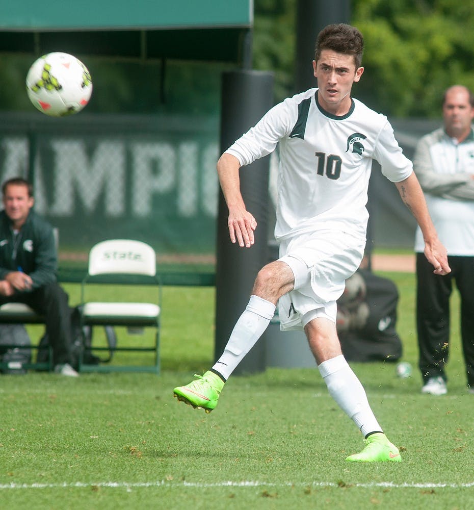 <p>Junior midfielder Jay Chapman passes the ball upfield during the game against Loyola-Chicago on Sept. 14, 2014, at DeMartin Soccer Stadium at Old College Field. Raymond Williams/The State News</p>