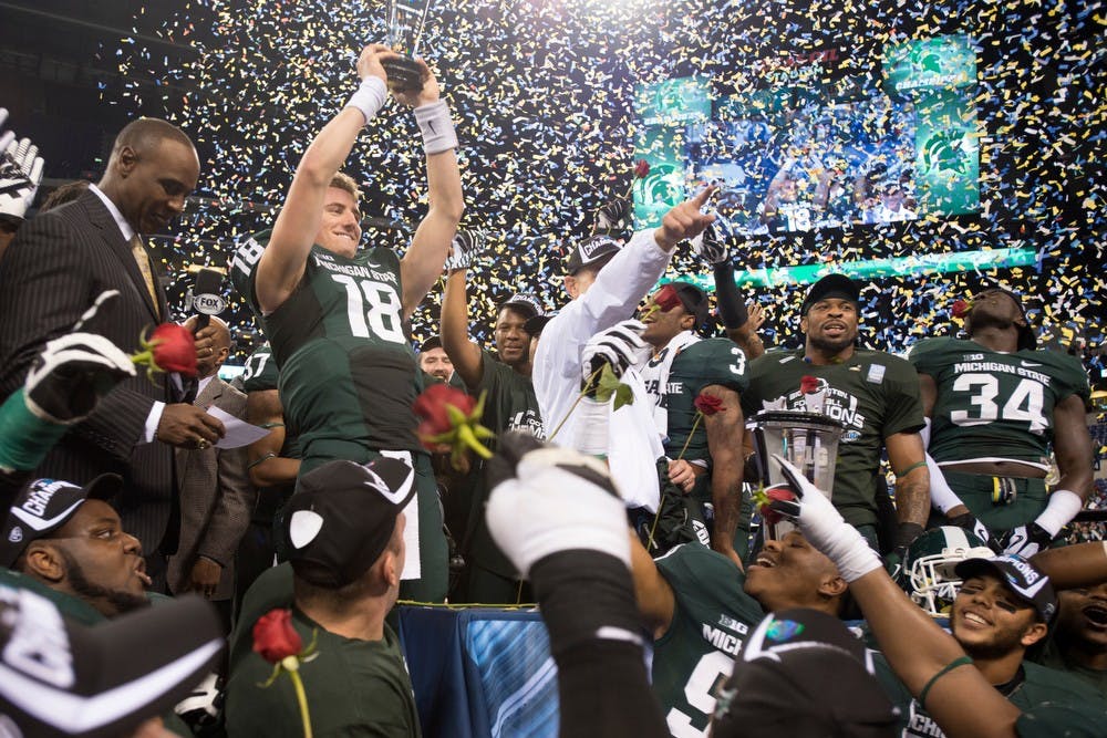 	<p>The Spartans celebrate sophomore quarterback Connor Cook&#8217;s most valuable player award and their win over Ohio State Dec. 7, 2013, at Lucas Oil Stadium in Indianapolis for the Big Ten Championships. The Spartans defeated the Buckeyes 34-24. Julia Nagy/The State News</p>