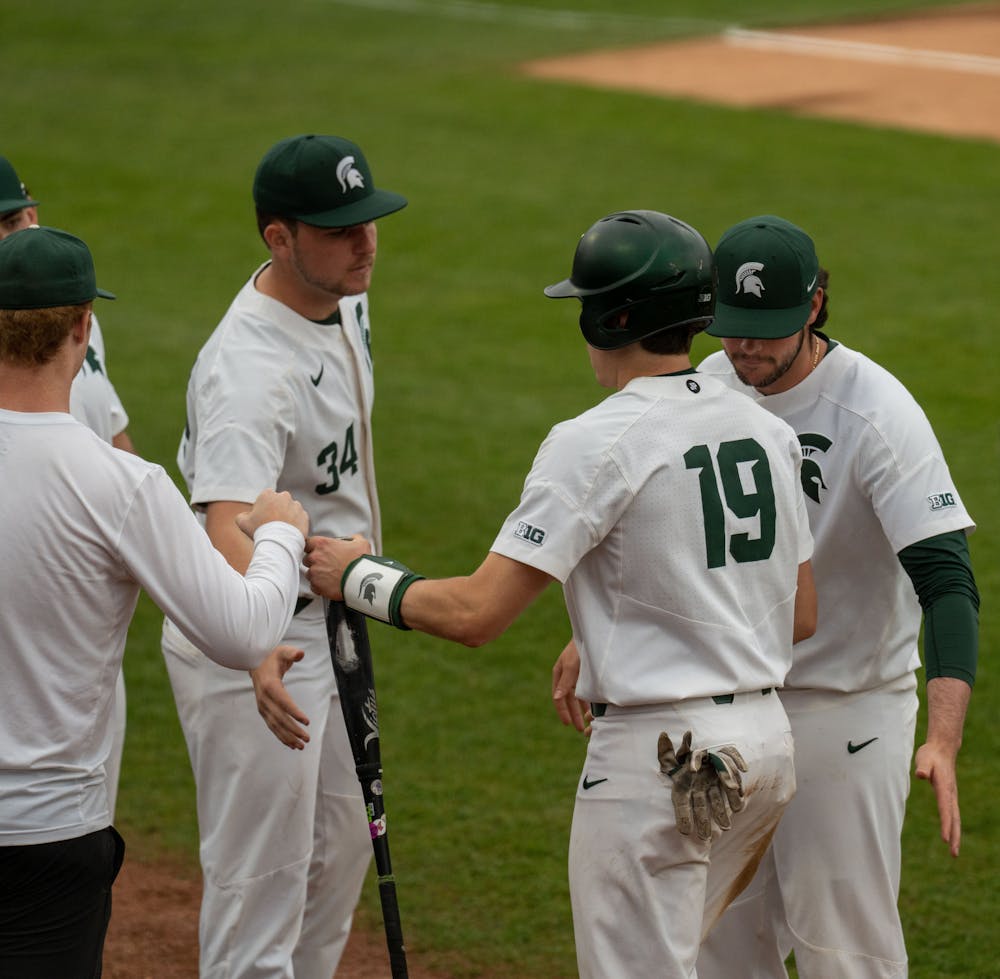 <p>After redshirt freshman catcher Bryan Broeker scored a run during the bottom of the fourth inning, his teammates congratulate him. MSU lost 18-7 against Western Michigan on April 13, 2022. </p>