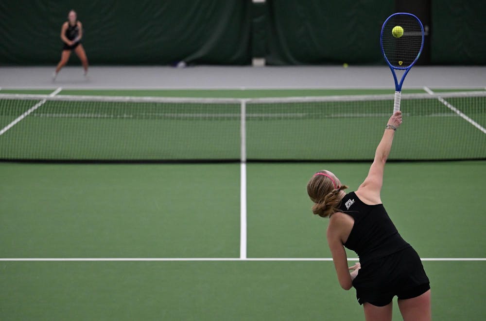 Madeleine Rexroat, a sophomore, serves during a singles match at the MSU Tennis Center on Friday, Feb. 6, 2026, in East Lansing.