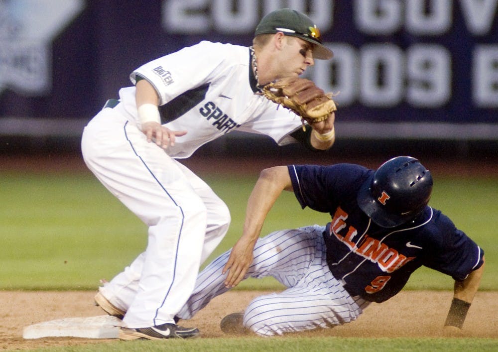 Sophomore infielder Ryan Jones attempts to tag out Illinois shortstop Josh Parr as he steals second base on May 28, 2011 at Huntington Park in Columbus, Ohio. The Spartans fell to the Fighting Illini, 9-1. Kat Petersen/The State News