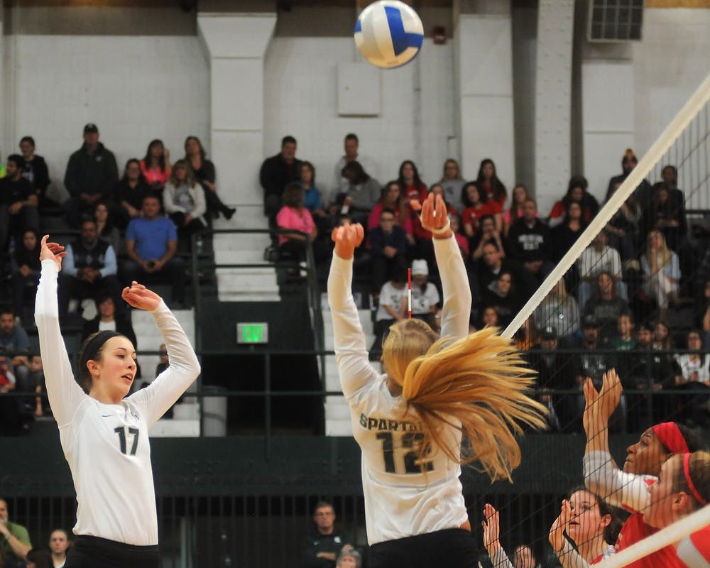 <p>Freshman middle blocker Alyssa Garvelink and freshman setter Rachel Minarick prepare a spike Nov. 22, 2014 during the game against Rutgers at Jenison Field House. The Spartans defeated the Scarlet Knights, 3-0. Dylan Vowell/The State News</p>