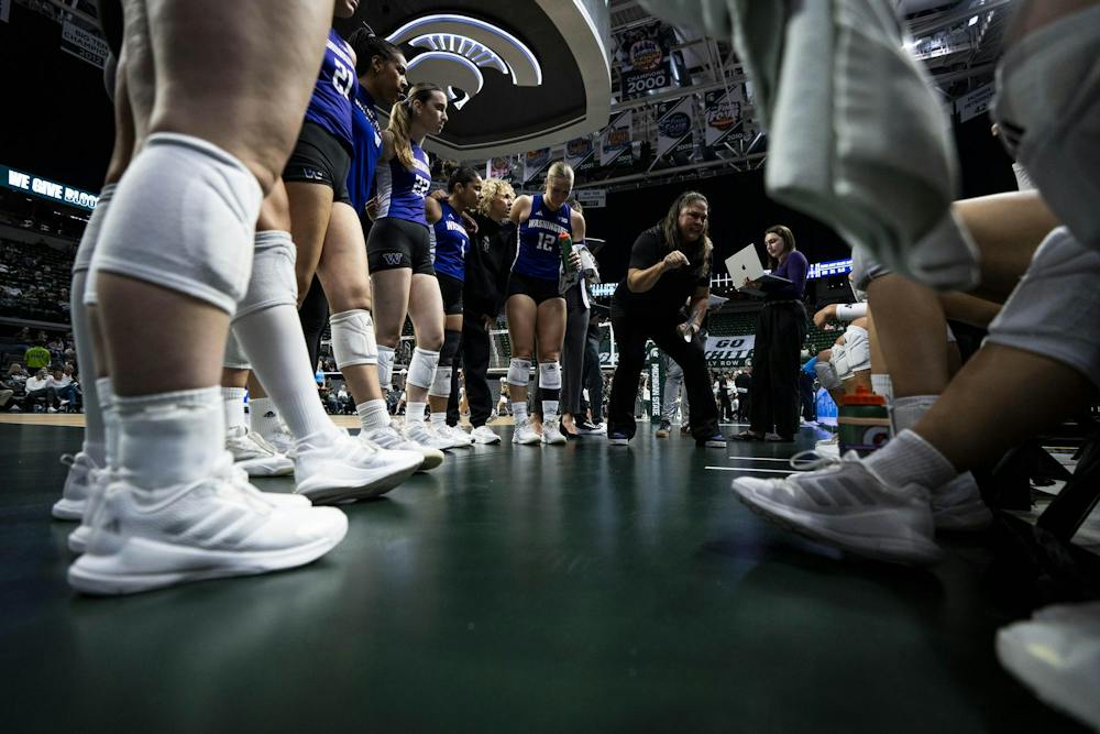 University of Washington volleyball head coach Leslie Gabriel leads her team during a timeout during a match at the Breslin Center in East Lansing, Mich., on Friday, Sept. 2026.
