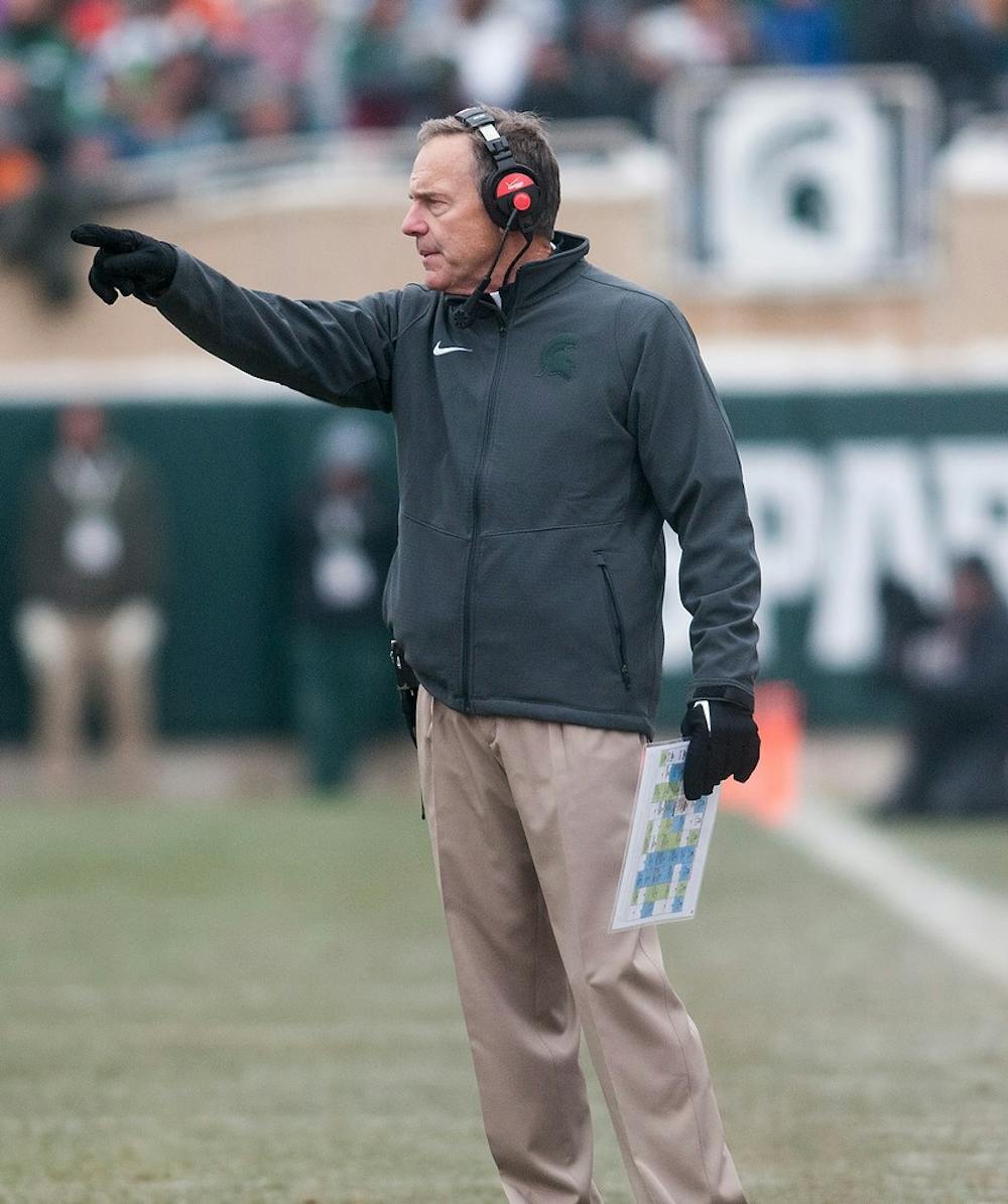 <p>Head Coach Mark Dantonio directs his team Nov. 22, 2014, during the game against Rutgers at Spartan Stadium. The Spartans defeated the Scarlet Knights, 45-3. Aerika Williams/The State News </p>