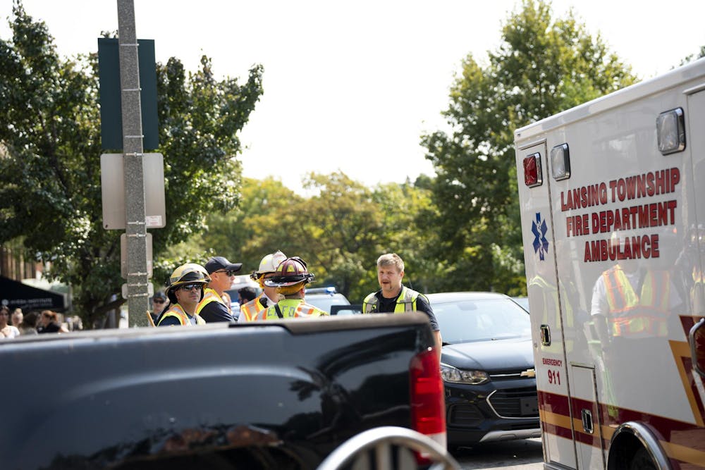 Lansing Township paramedics discuss cleanup for accident. 