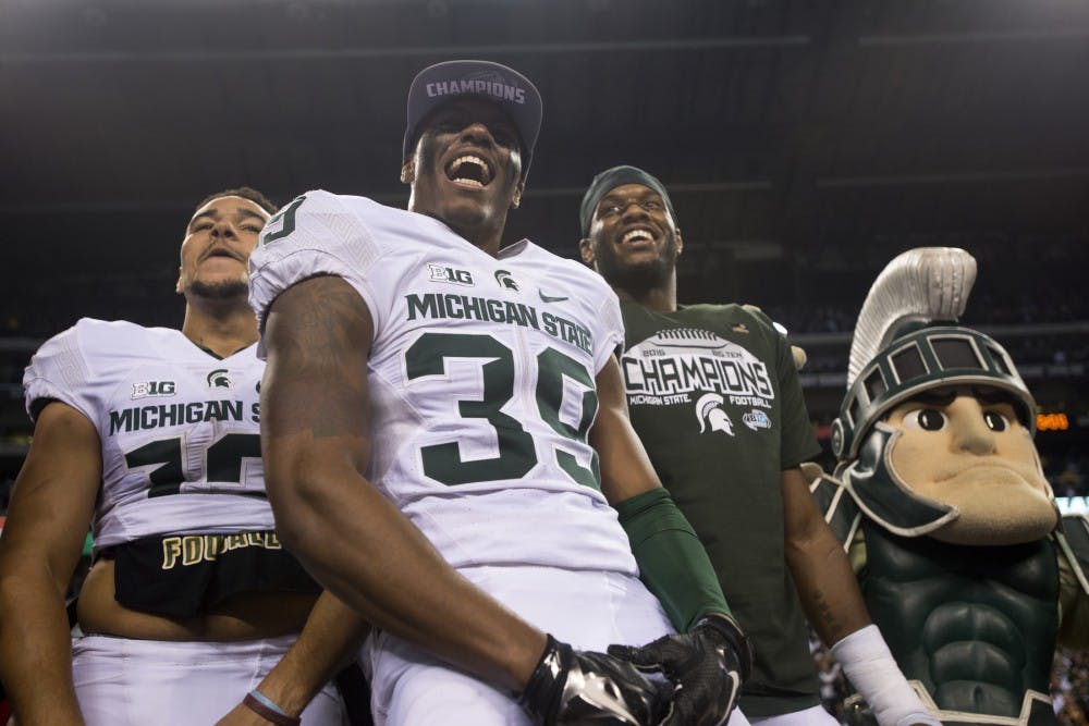 From left to right, junior wide receiver R.J. Shelton, junior cornerback Jermaine Edmondson and senior defensive end Shilique Calhoun celebrate on Dec. 5, 2015 after the Big Ten championship game against Iowa at Lucas Oil Stadium in Indianapolis. The Spartans defeated the Hawkeyes, 16-13.