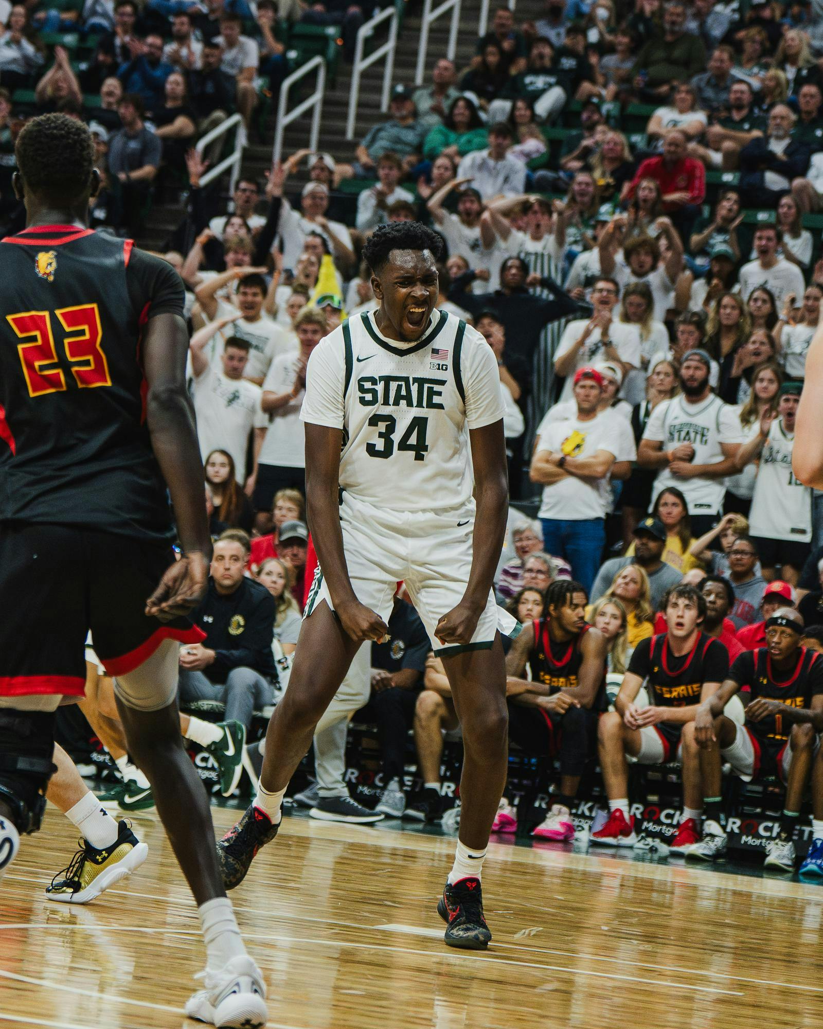 MSU sophomore forward Xavier Booker (34) flexes after a slam dunk during an exhibition matchup against Ferris State at the Breslin Center on Oct. 29, 2024. 