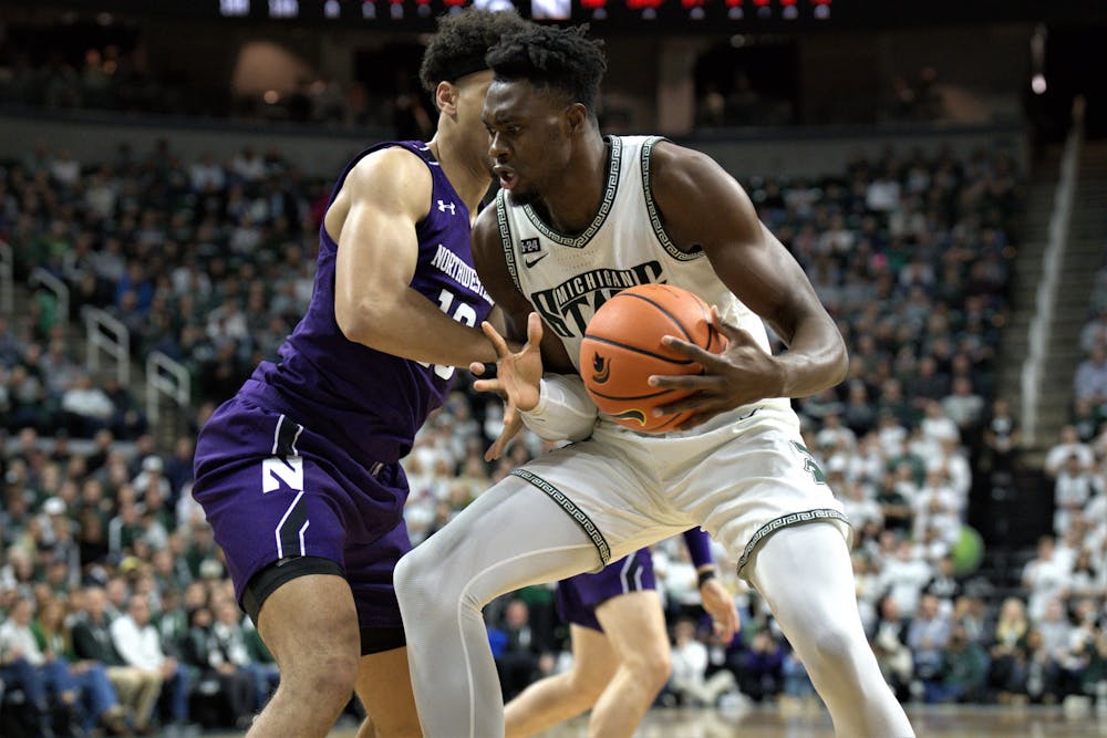<p>Spartan center Mady Sissoko attempts to get around his Wildcat opponent during the match at the Breslin Center on Dec. 4, 2022. ﻿</p>
