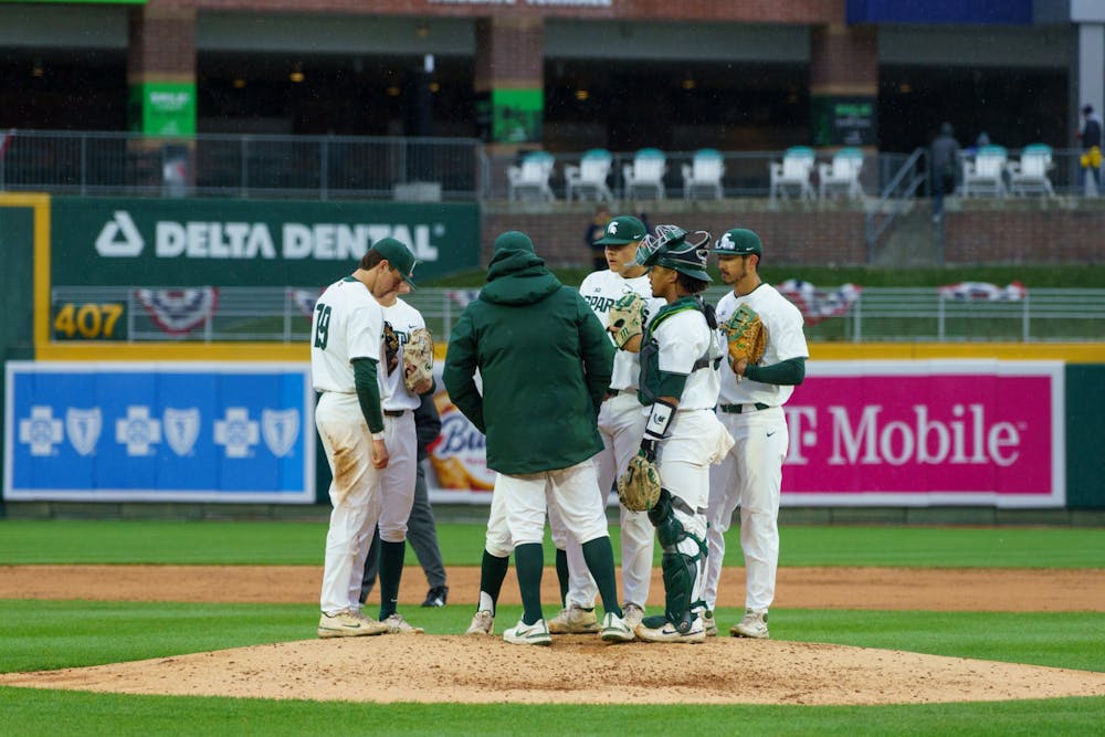 <p>Michigan State huddling around their coach in the middle of the top of the sixth. Michigan State lost 18-6 to Michigan on April 15, 2022 at the Lugnut Stadium.</p>