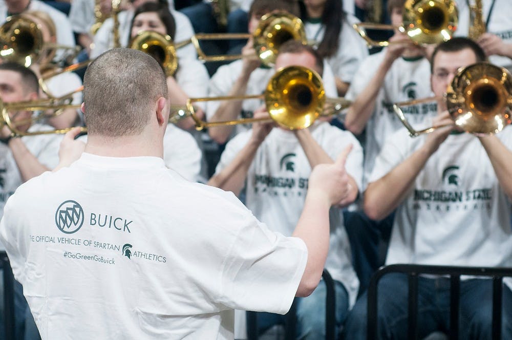 <p>Lansing resident Barry Greer directions the Spartan Band during the mens basketball game against Michigan Feb. 1, 2015 at Breslin Center. Greer hasn't missed an MSU mens basketball game in 23 years, and leads the band at every home game.  Alice Kole/The State News</p>