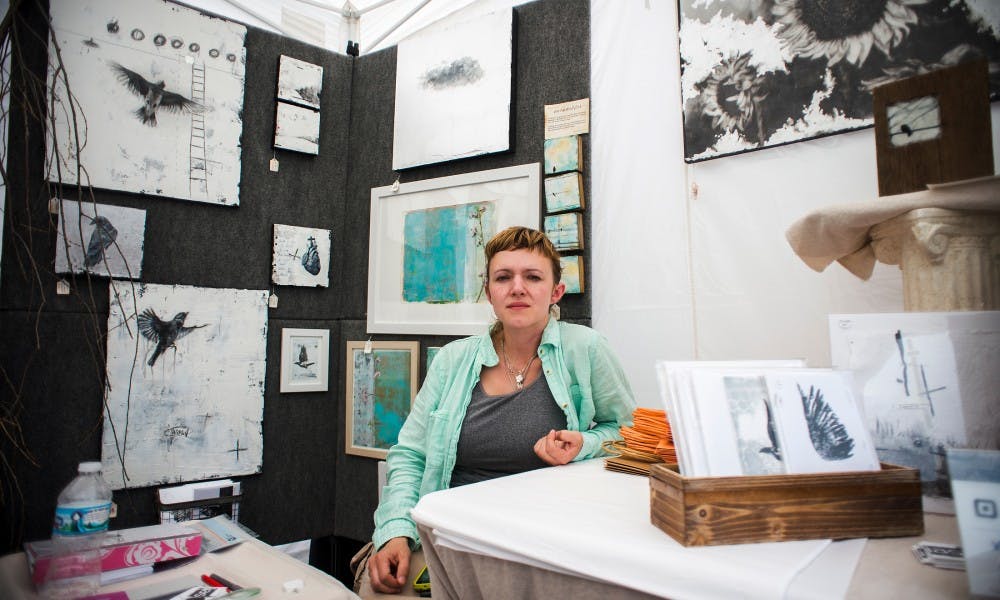 Lansing resident Ingrid Blixt poses for a picture during the East Lansing Art Festival on May 21, 2017. The East Lansing Art Festival is an event meant to bring the East Lansing community together through appreciation of art.