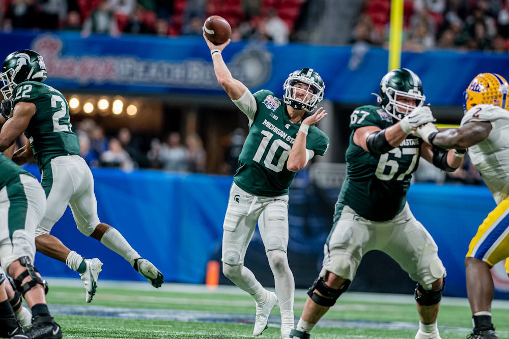 <p>Redshirt sophomore quarterback Payton Thorne throws a ball downfield during the Spartans 31-21 victory against Pitt in the Chick-Fil-A Peach Bowl on Dec. 30, 2021.</p>