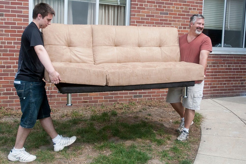 	<p>Economics junior Kenny Welsh, left, and his father Bill Welsh carry a futon Aug. 26, 2013 in front of East Shaw Hall. This is Welsh&#8217;s first year living in Shaw Hall. Katie Stiefel/The State News</p>