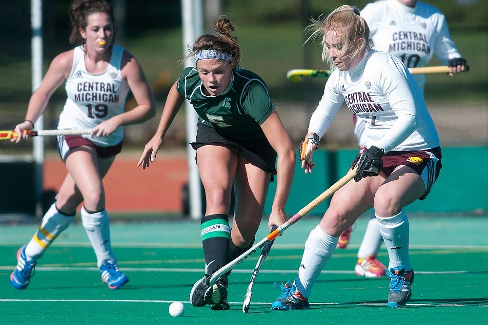 <p>Senior forward Abby Barker attempts to retrieve the ball from Central Michigan back Chloe McIlwaine on Oct. 26, 2014, at Ralph Young Field. Barker scored both goals in the second half the game. The Spartans defeated the Chippewas, 2-0. Raymond Williams/The State News </p>