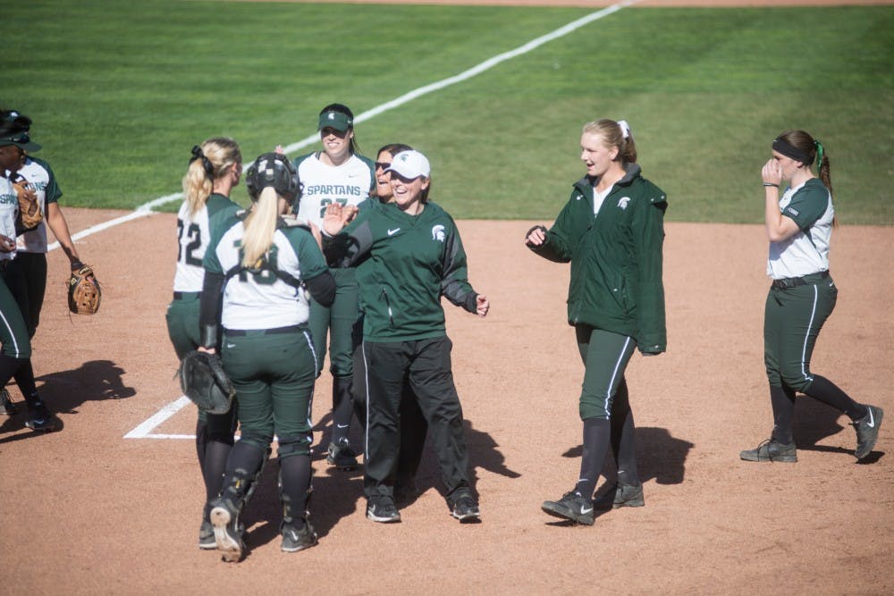 Assistant coach Kaela Jackson high fives players during the game against Broncos on March 29, 2016 at Secchia Softball Stadium. The Spartans defeated the Western Broncos, x-x.