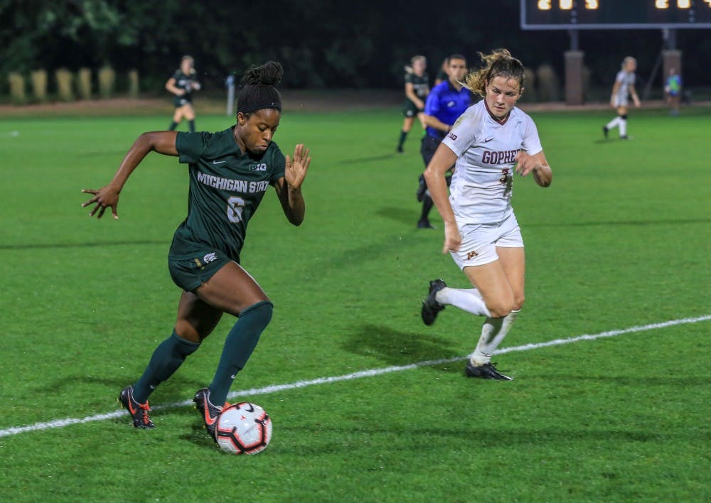 <p>Junior forward Lydia Franks (6), and Minnesota’s defense Delaney Stekr (3), fight for the ball during the game against Minnesota at DeMartin Stadium on Sept. 20, 2018. The Spartans and Gophers tied in double overtime, 0-0.</p>