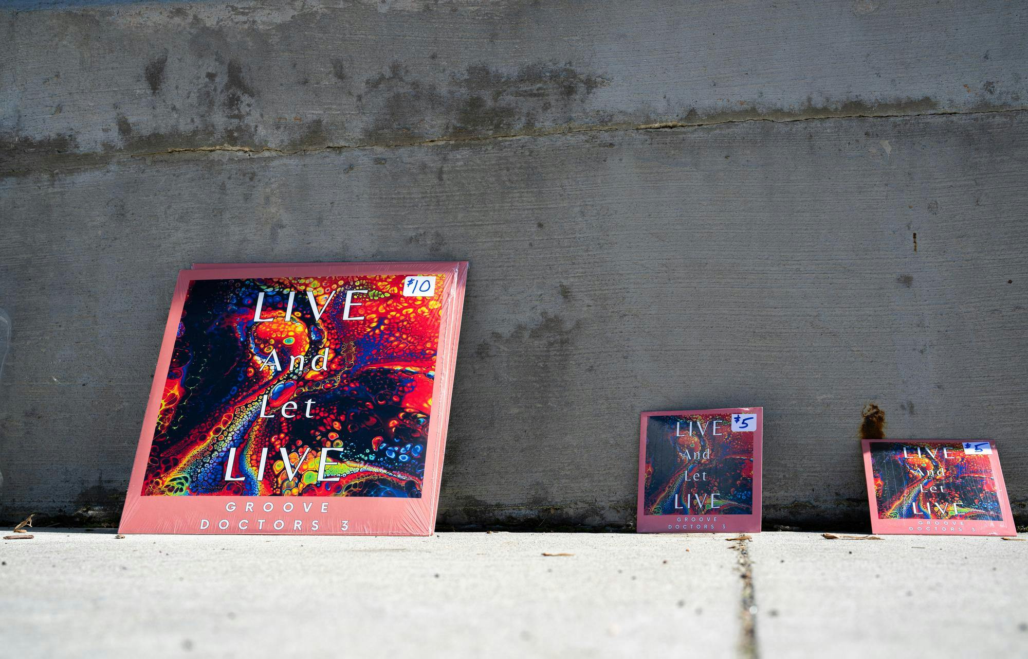 The Groove Doctors 3, comprised of Michigan State professors and faculty, lay out their recent album, "Live and Let Live," prior to a performance at the Meridian Township Farmers' Market at Meridian Mall in Okemos, Michigan on May 24, 2025. 