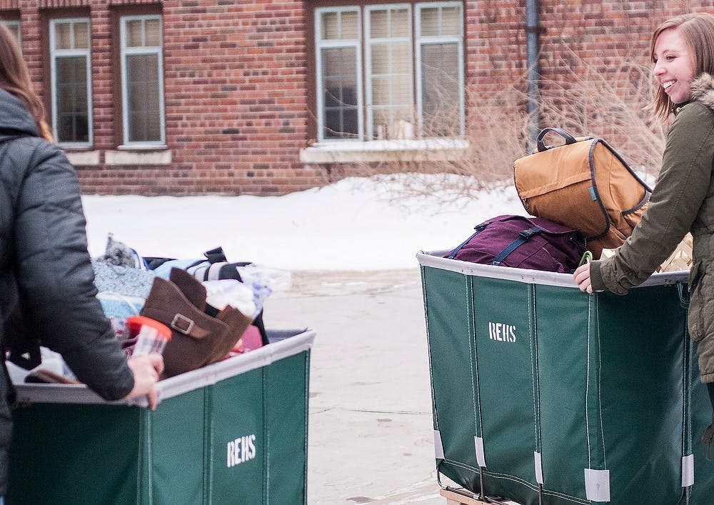 <p>Political theory and democracy sophomore Allison Gilbert and pre nursing sophomoreTaylor White move in for spring semester to Landon Hall Jan. 11, 2015, at MSU. They enjoy the new amenities of the remodeled hall. Hannah Levy\The State News</p>